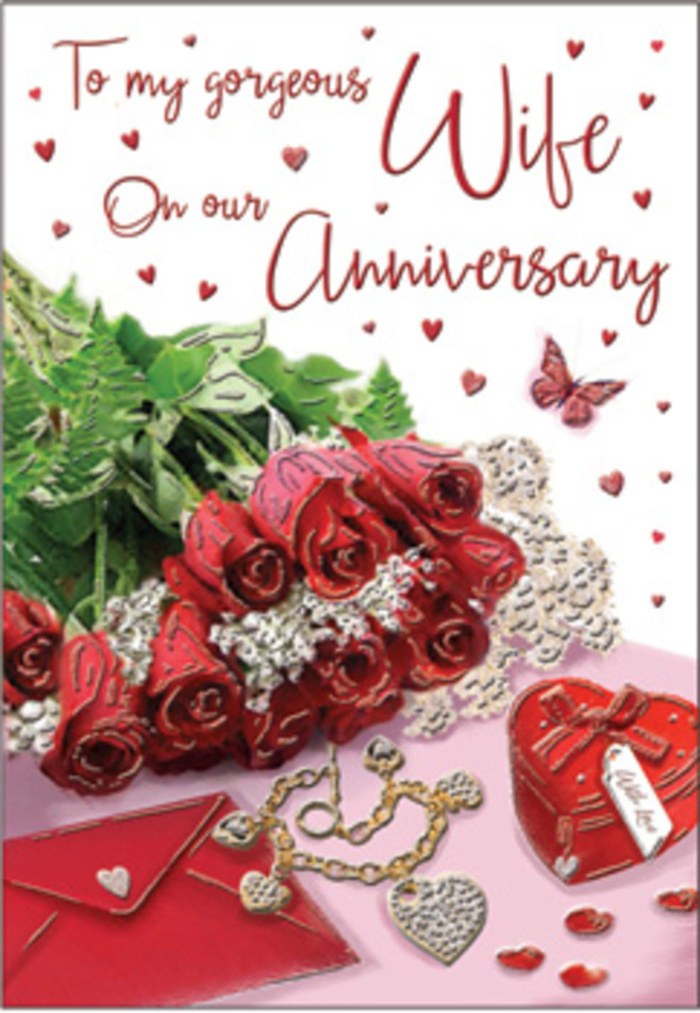 A richly romantic anniversary card is styled as a thoughtful still life, echoing the polished elegance of Canary Wharf while keeping the warmth of a private celebration. In the centre, a small bouquet of classic red roses is carefully arranged, each flower fully open, its velvety petals curling outward in deep, luxurious shades of crimson. Fresh greenery nestles around the blooms, adding soft texture and framing their intensity. Just beside them lies a neatly placed envelope, suggestive of a heartfelt note written in flowing script, ready to be paired with the card. A dainty heart-shaped box and a piece of jewellery glimmer gently, their surfaces catching the light in the same way the nearby waters of the Thames shimmer against the skyline. Scattered hearts in varying sizes adorn the surrounding space, some printed, some perhaps crafted from paper or foil, creating a sense of movement and gentle celebration across the design. A single butterfly motif appears, poised as if about to lift off, adding a touch of whimsy and hope. The entire scene is bathed in a diffused, natural light that softens shadows and highlights the satin sheen of rose petals and the smooth grain of the card. It feels like a moment paused in time, the sort of intimate gesture a couple might share after an anniversary dinner in one of Canary Wharf's riverside restaurants, perfectly capturing the enduring affection and gratitude that deepen year by year.