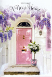 The photograph presents a tranquil doorway in Canary Wharf dressed as if for a quiet, heartfelt housewarming, every element working together in soft pastel harmony. Above the entry, wisteria cascades in long, fragrant strands of lavender and lilac, each bloom forming small clusters that sway slightly, creating a natural curtain against whitewashed walls. The building itself feels calm and understated, allowing the feature door-a beautifully painted pink, with a companion shutter in the same shade-to glow warmly at the centre. The pink is gentle rather than bold, like the inside of a seashell, and the smooth finish catches soft daylight that could be drifting in from nearby South Dock. Resting on the doorstep is a vintage-style metal bucket in a quiet grey tone, carefully filled with an abundant bouquet of white and cream roses. The roses are plush and generously open, their velvety petals curling outwards, interspersed with fresh green foliage that adds depth and a whisper of woodland scent. Around the base of the bucket, a pale pink ribbon is tied in an elegant bow, its tails lying lightly against the step, echoing the rosy shades of the door and knitting the scene together visually. The lighting feels gentle and forgiving, perhaps mid-afternoon, with subtle shadows that give depth without harshness. Altogether, the image suggests the moment just before friends arrive to celebrate someone's new home in E14, a floral gesture that feels personal and welcoming-perfect for a local delivery that turns a simple doorstep into a place of comfort, joy, and new beginnings.